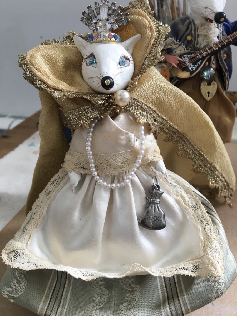 A small fox figure in lace and gold, made from found materials, by Bobbi